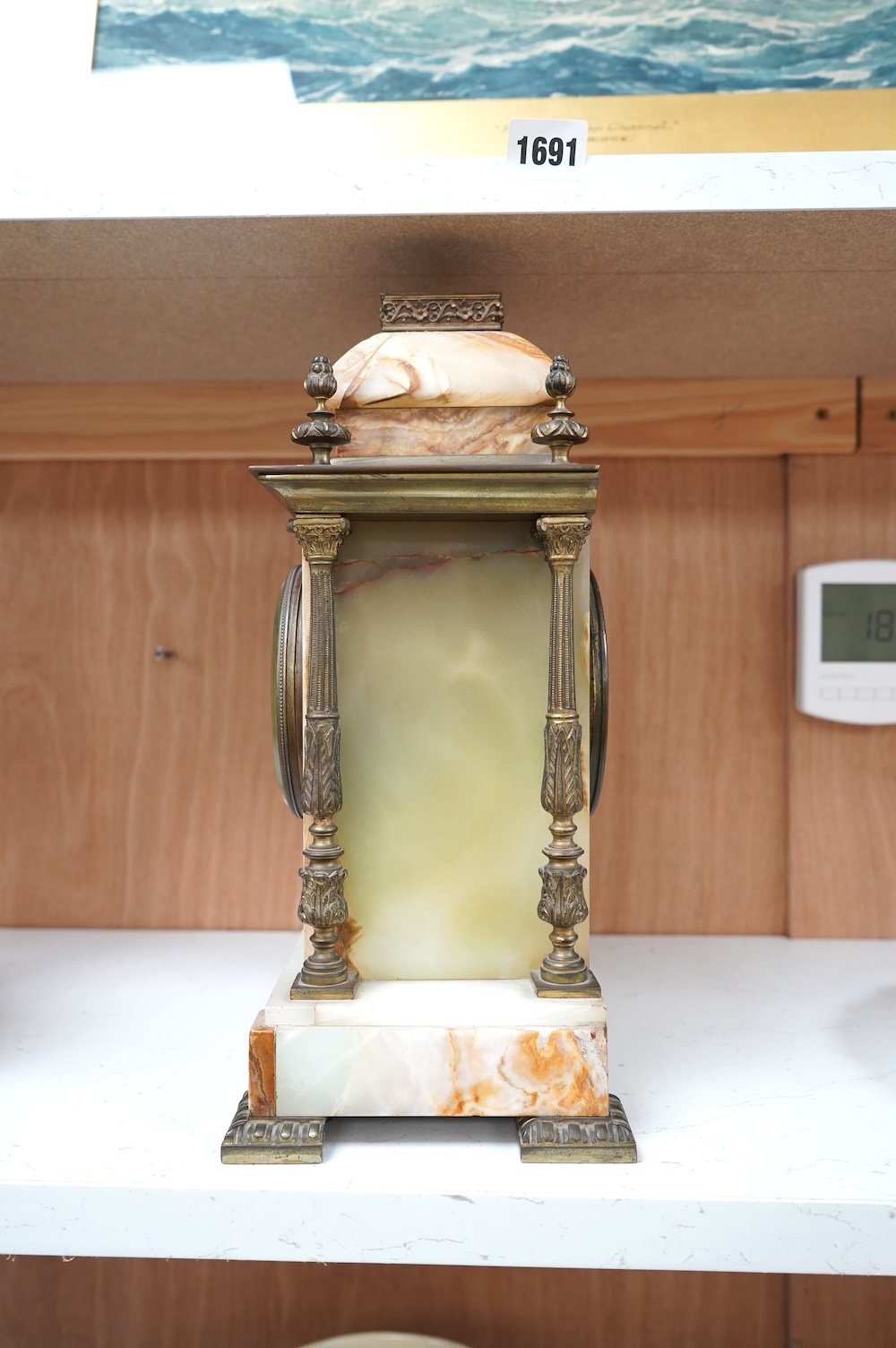 An early 20th century marble and onyx mantel clock with enamel dial with pendulum, no key, 32cm high. Condition - fair, untested